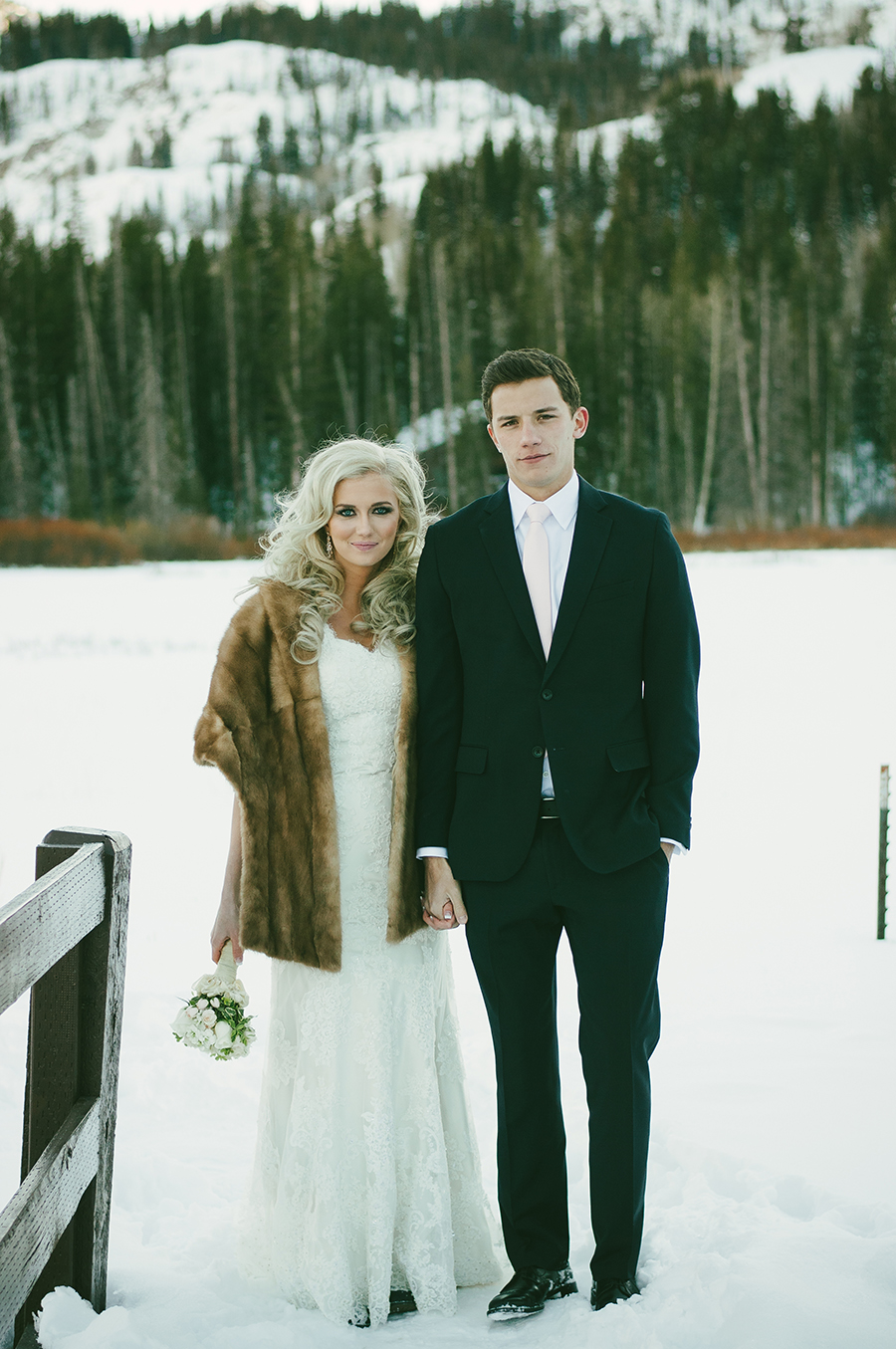 A bride & groom in front of the pine tree background up Big Cottonwood Canyon, Utah for their winter wedding.