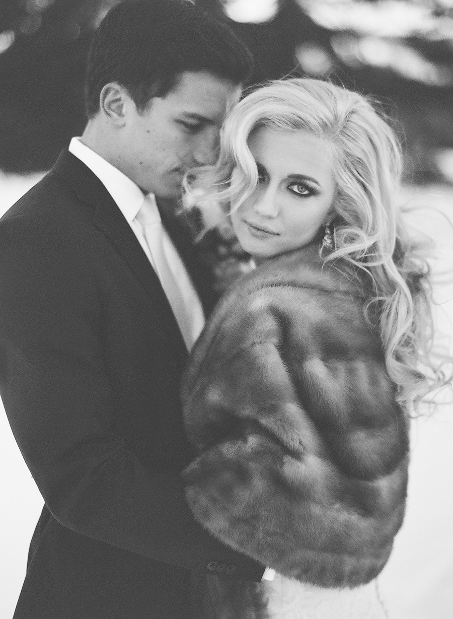 Winter bride in fur coat and bombshell wedding hair.