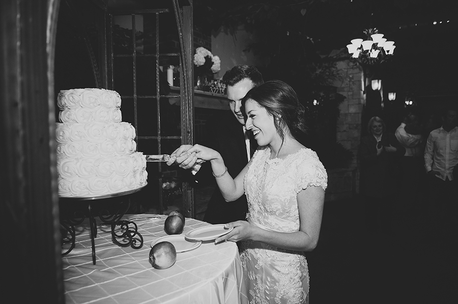 Black and white, classic wedding cake cutting photo.