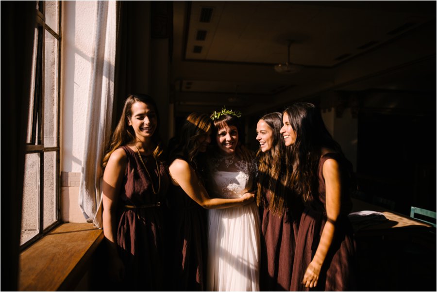 Bridesmaids helping the bride get ready