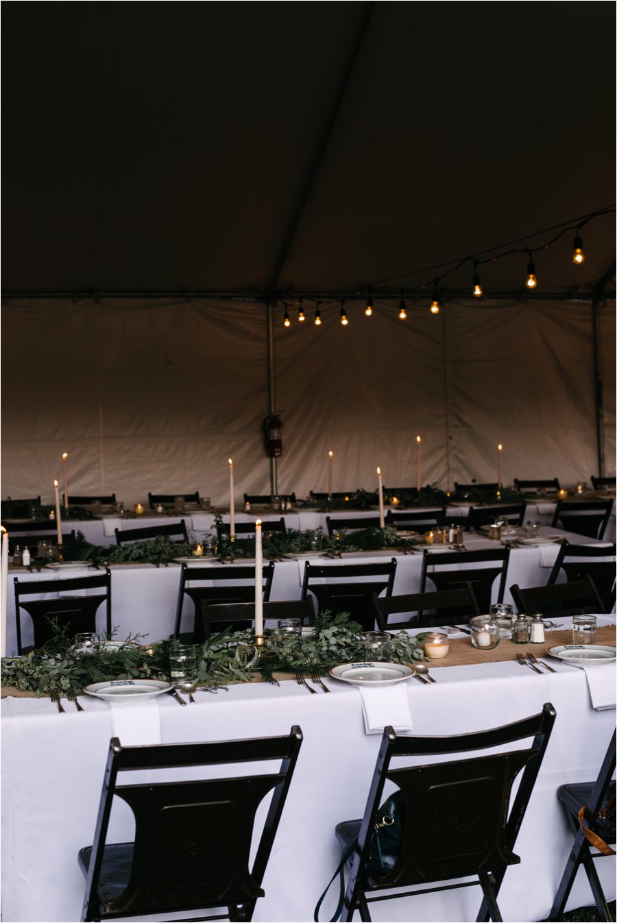 Romantic wedding tables with candles, greenery, and mid-century chairs