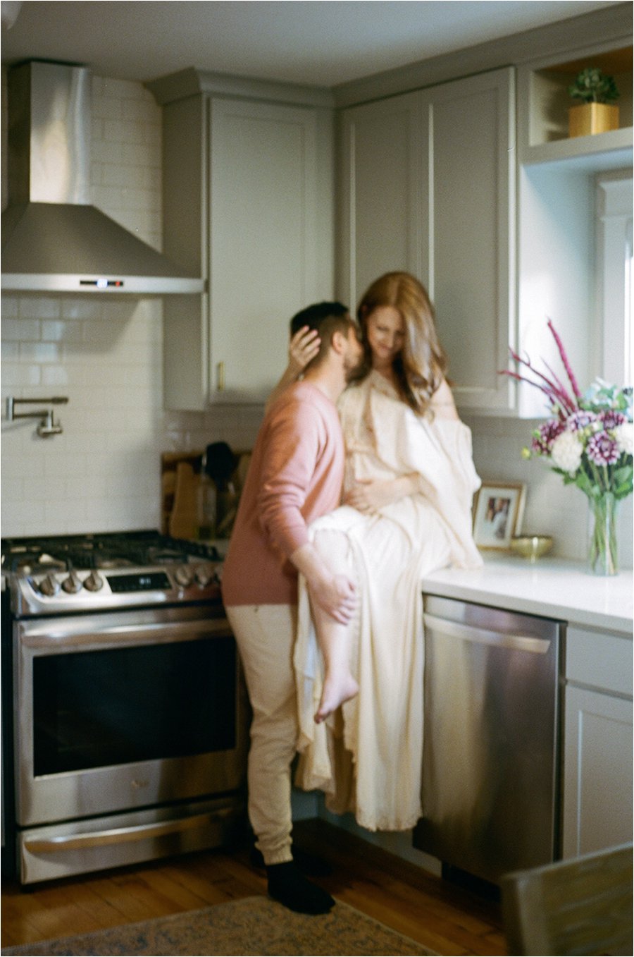 Couples session in a kitchen, wearing a Fillyboo dress.